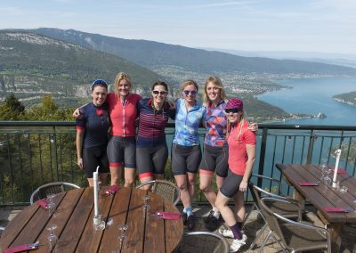 Cyclists overlooking mountains and Lake Annecy