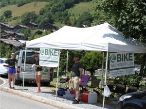 Team offering drinks to cyclists