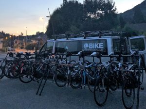 Road bikes on a rack by a minibus