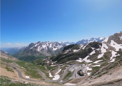 Twisty mountain road with snow-capped mountains